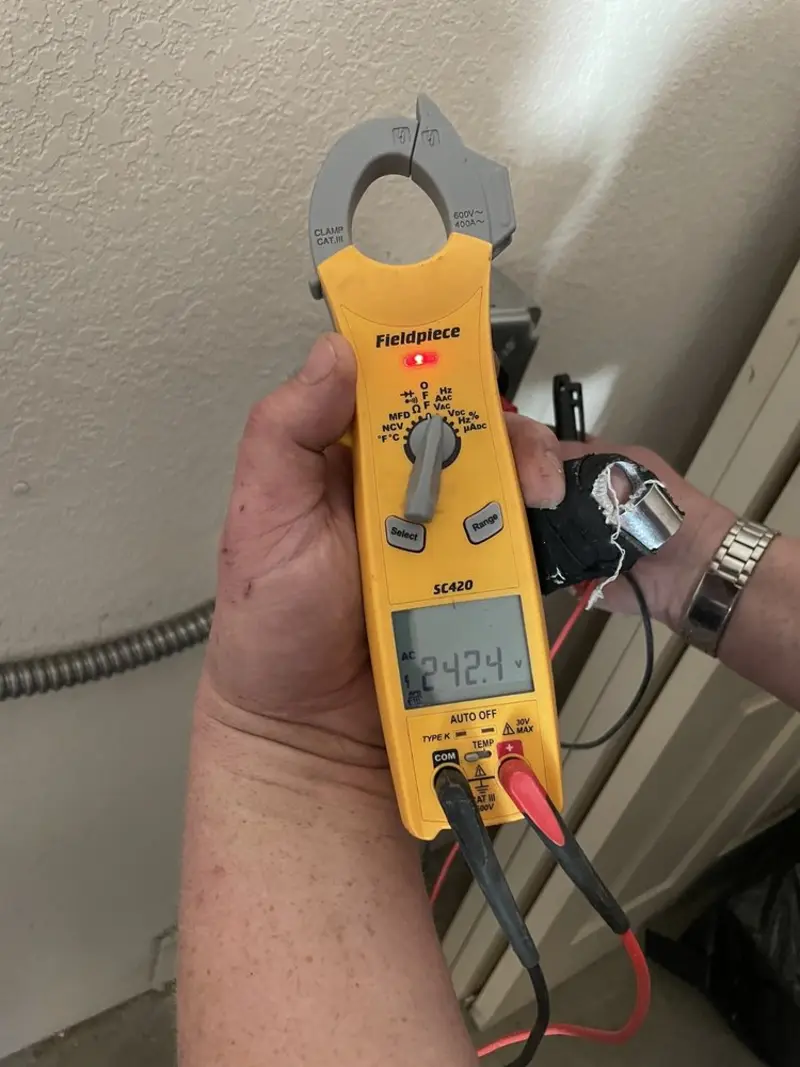 Voltage testing with clamp meter during Outlet Installation in Meadow Oaks